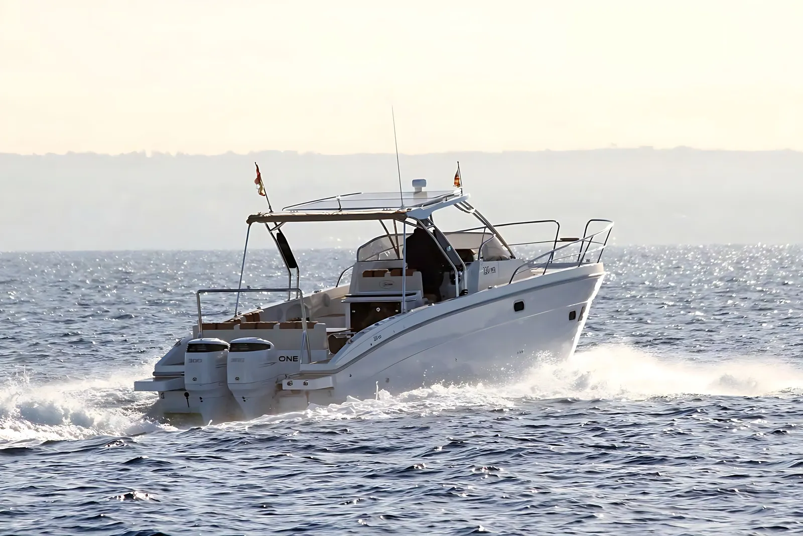 Saver 330 walkaround running at speed on a bright, glittering sea, white spray trailing from her outboard engines