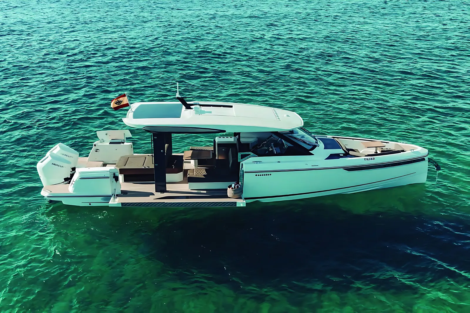 Saxdor 400 at anchor on green open water, seen from above with a side terrace folded down