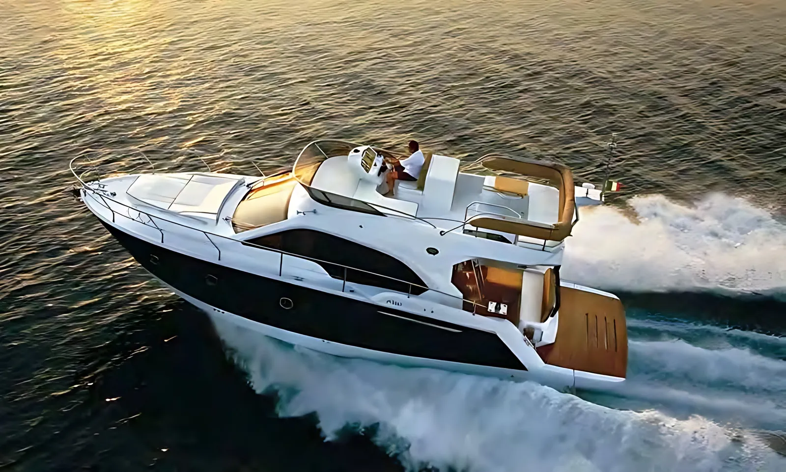 Sessa 40 Fly running at speed at sunset, seen from above with a white wake on golden water