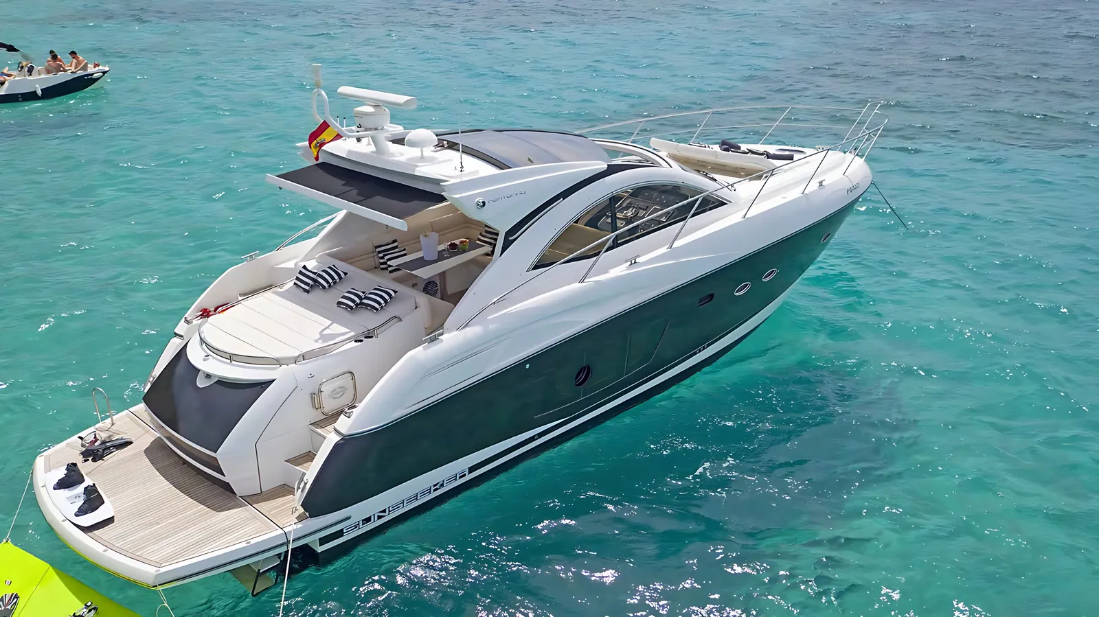 Sunseeker Portofino 48 at anchor in turquoise water, seen from above with her hardtop and aft sunpad